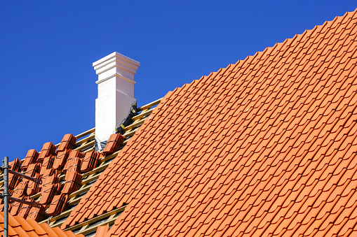 This is an image of a roof replacement with clay tiles.